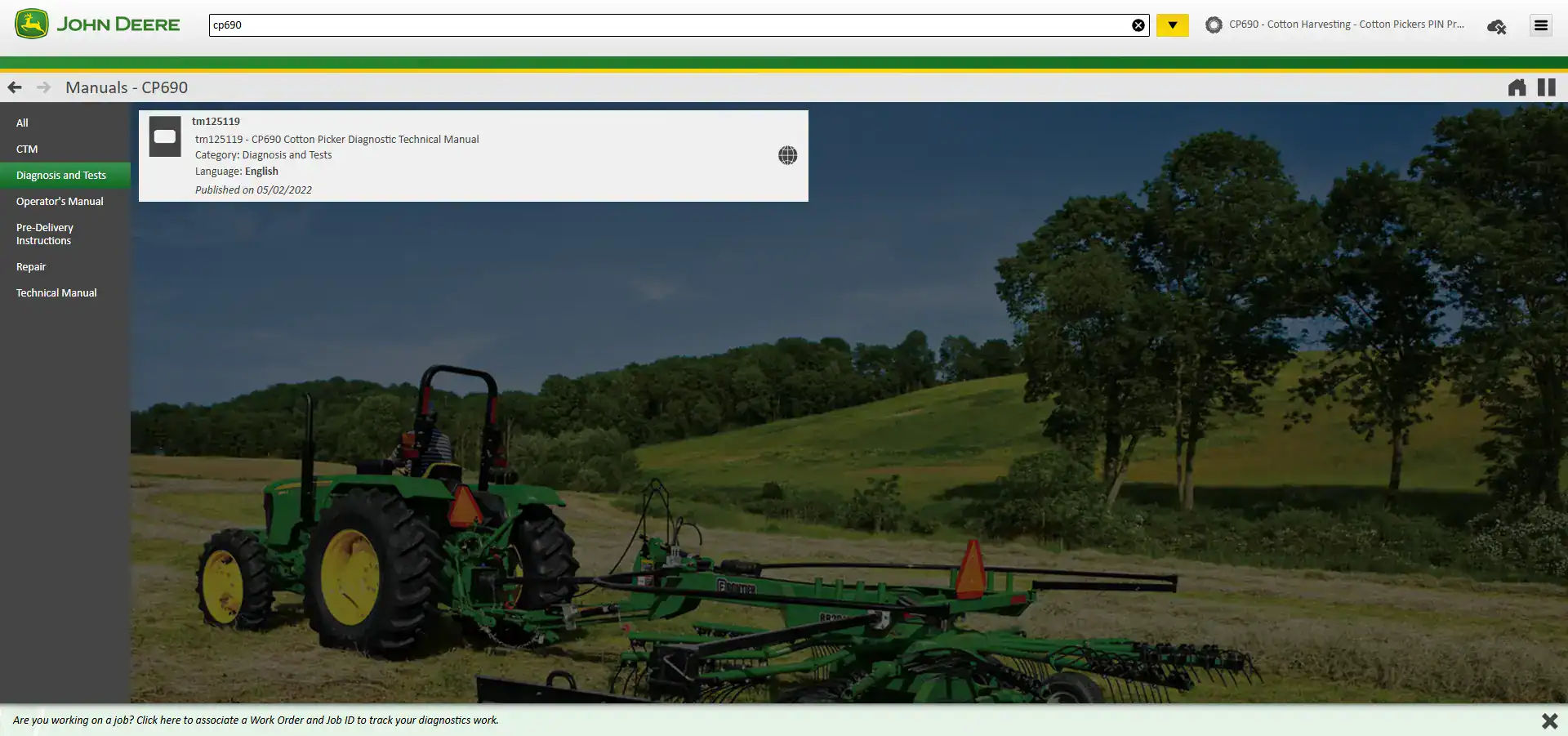 John Deere green tractor performing cotton harvesting in a rural field with trees in the background.