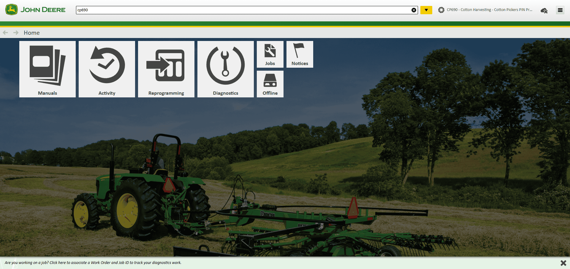 John Deere tractor with cotton harvesting equipment in a lush green field, representing advanced agricultural machinery and farm operation solutions.