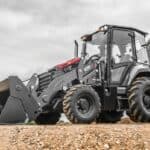 High-capacity CAT 420F backhoe loader on construction site with durable tires, equipped for heavy-duty earthmoving, excavation, and construction projects.