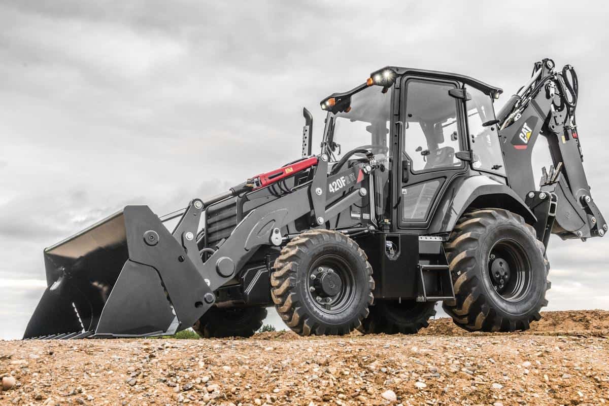 High-capacity CAT 420F backhoe loader on construction site with durable tires, equipped for heavy-duty earthmoving, excavation, and construction projects.