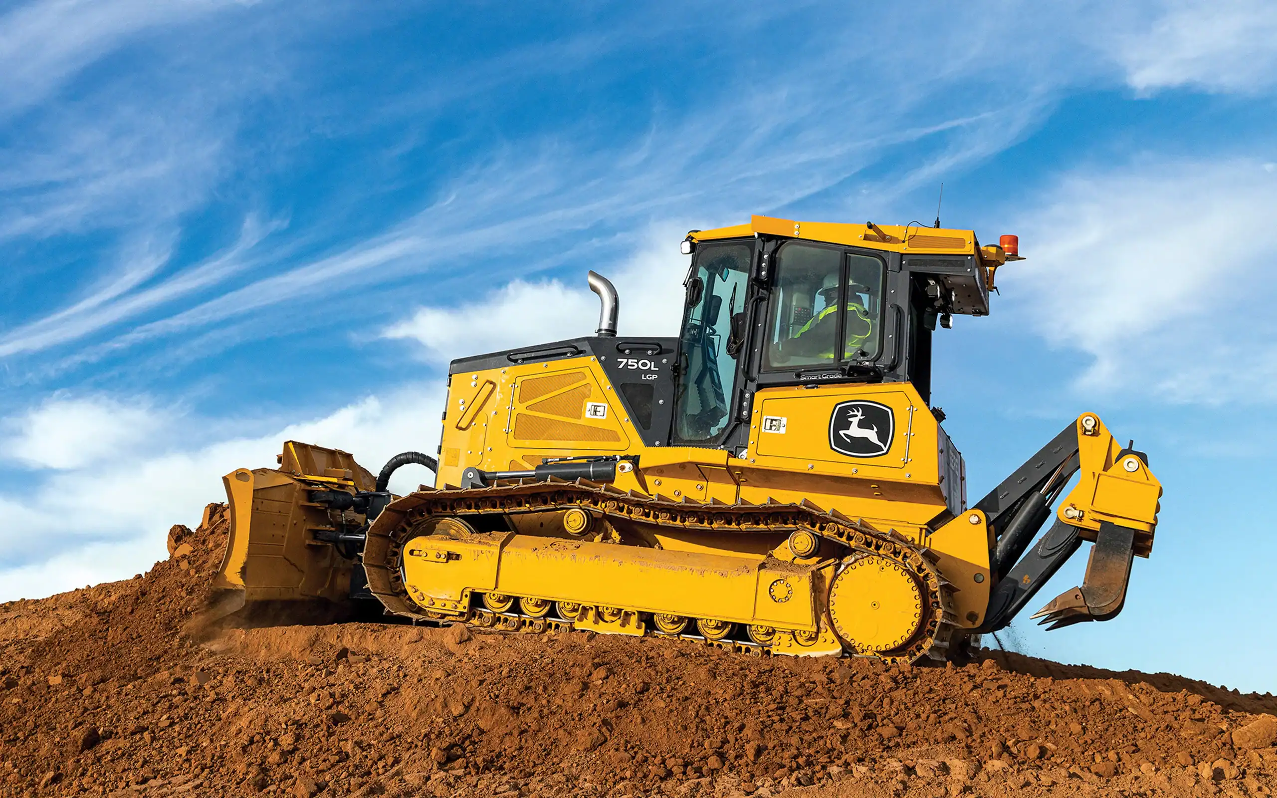 Yellow John Deere bulldozer at construction site on dirt hill, large construction equipment for earthmoving.